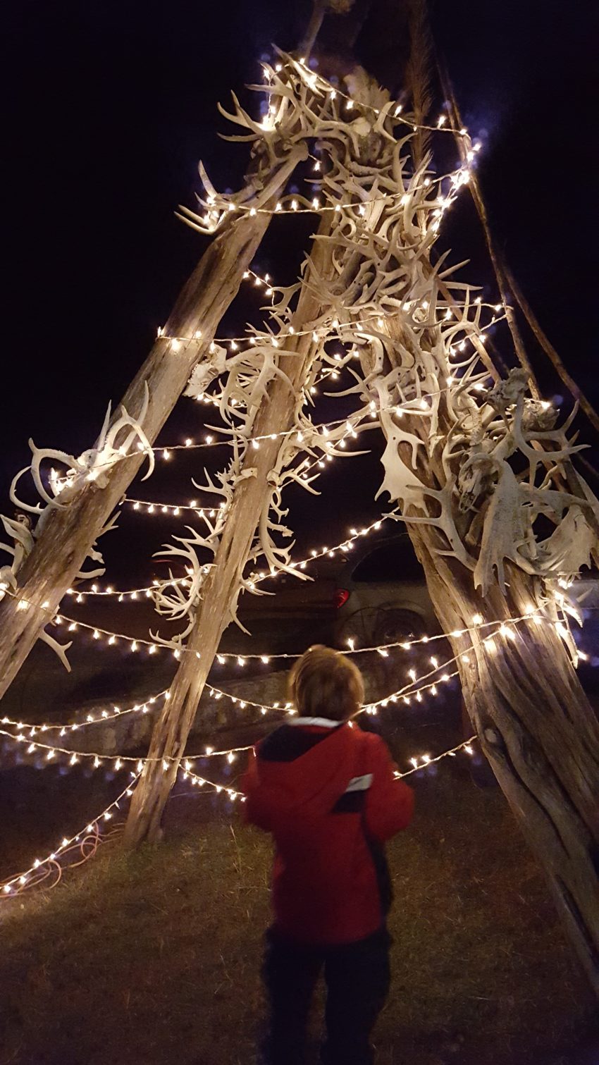 boy-admiring-ranch-decor-at-christmas-light-fest